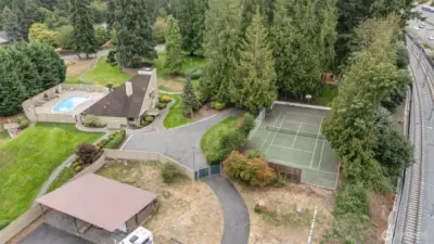 Arial view of clubhouse, pool, tennis courts and RV/boat parking area. Note the light rail line on right hand side of photo!