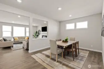 Formal dining room perfect for hosting. Photo is representational. Actual home is under construction and finishes and paint colors may vary. See site agent for details.