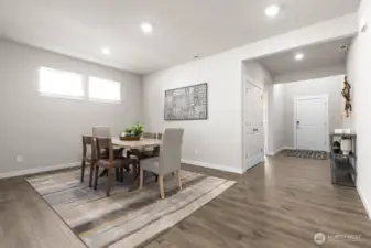 Formal dining room perfect for hosting. Photo is representational. Actual home is under construction and finishes and paint colors may vary. See site agent for details.