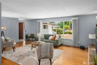 Hardwood flooring in living, dining, bedrooms, and underneath carpet in hallway.