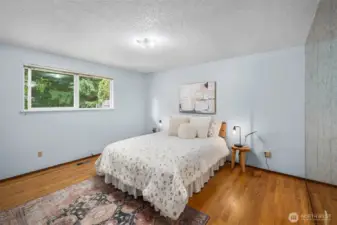 Primary bedroom with view of backyard.