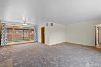 Living area plus dining room overlooking the back yard