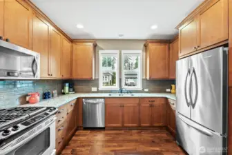 This former Model Home has so many upgrades: 42" cabinetry, Quartz counters & a full height backsplash.