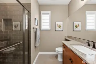 Guest bathroom with tiled floors, a custom walk-in shower, and Quartz countertop.